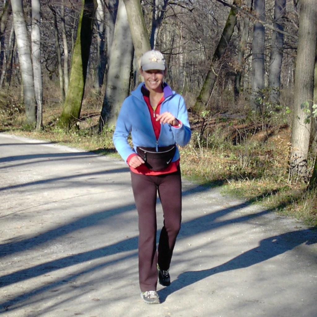Manuela Stoerzer walking alone outdoors, practicing mindful walking for awareness and presence, silver-haired actor and coach in natural surroundings